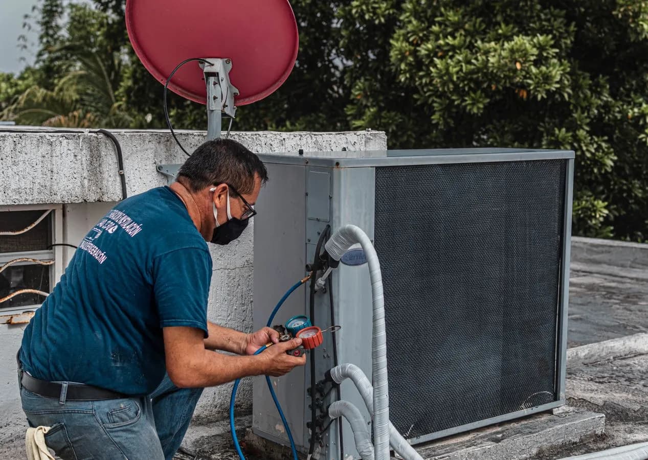 Technician diagnosing an outdoor air conditioning unit
